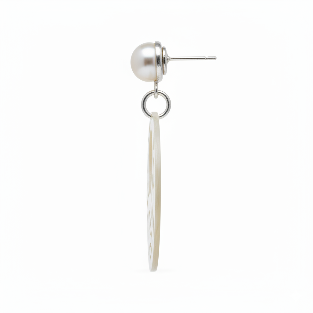Pearl earring with a dangling silver plate on a white background