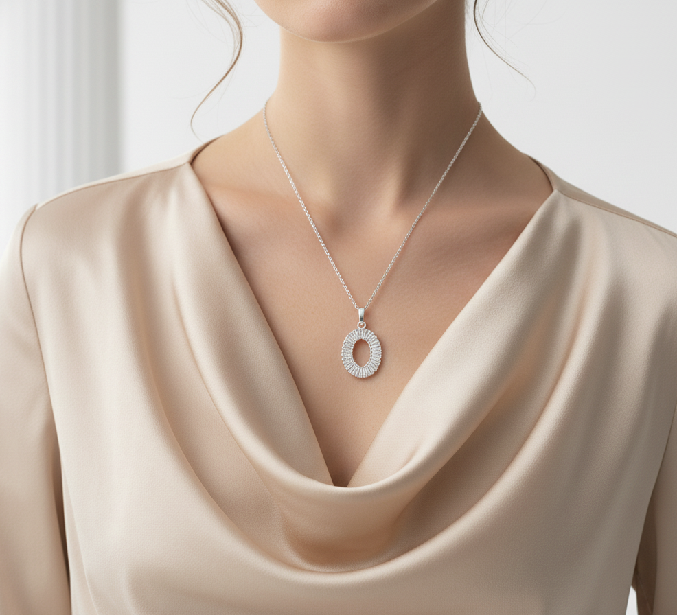 Necklace with a circular pendant on a mannequin wearing a beige dress.