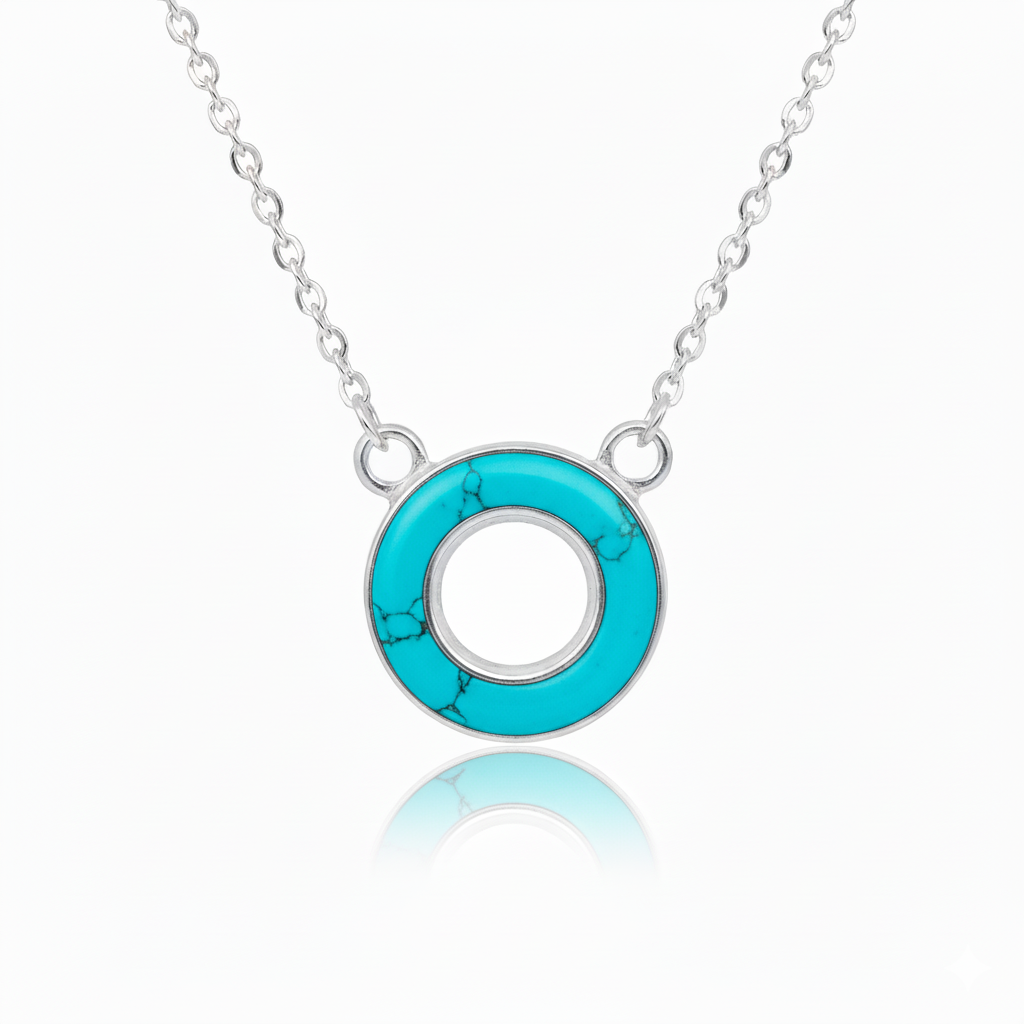 Turquoise circular pendant on a silver chain against a white background