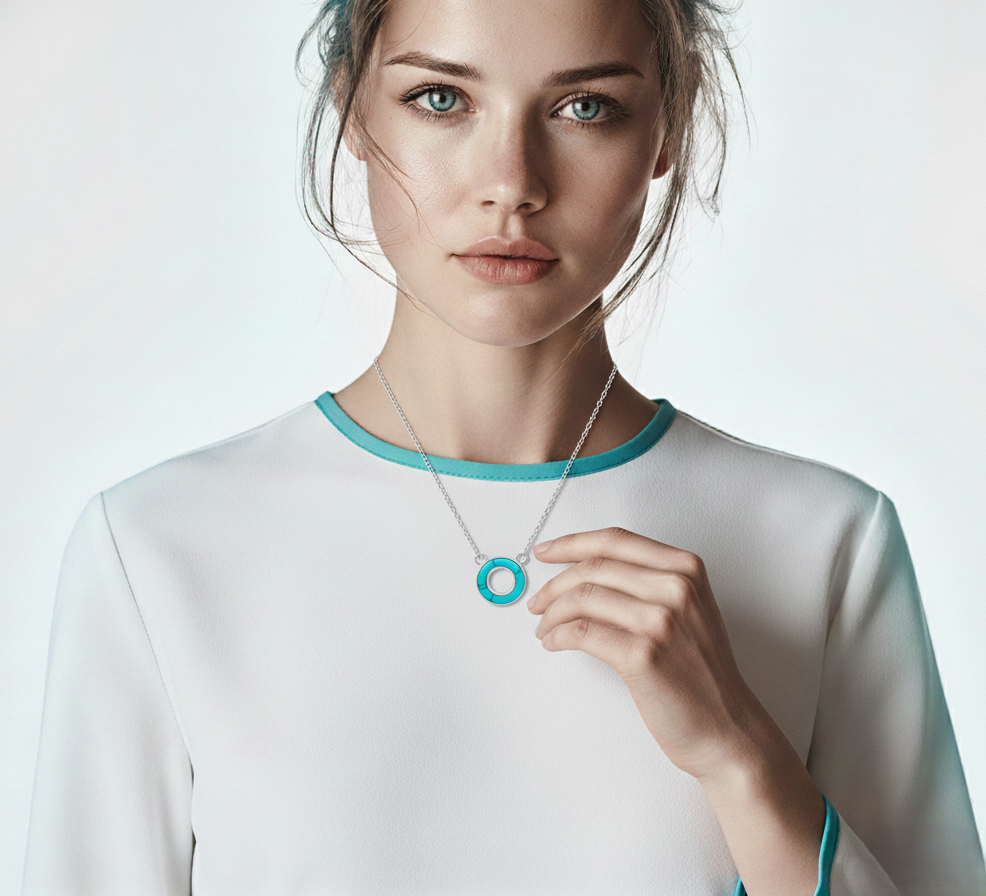 Woman wearing a necklace with a blue pendant against a white background